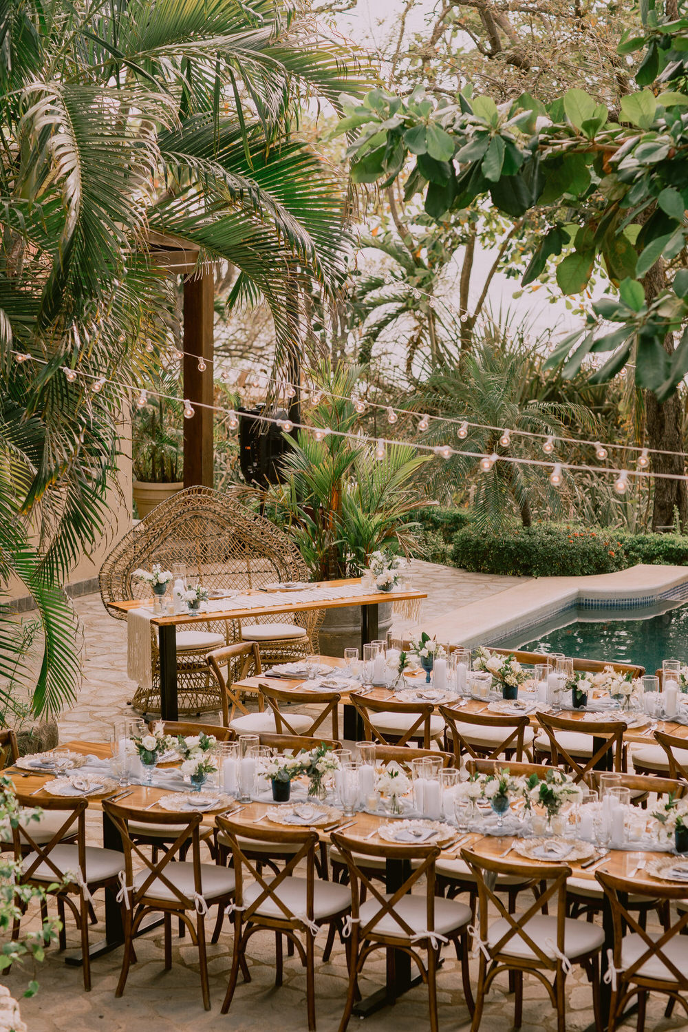 wedding reception decor with market lights by a pool