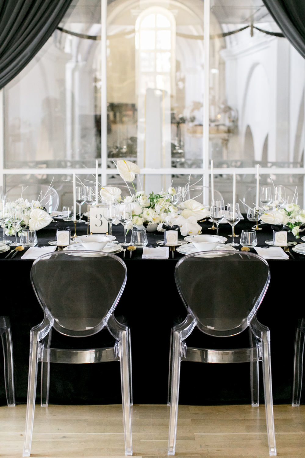 black and white wedding decor with ghost chairs