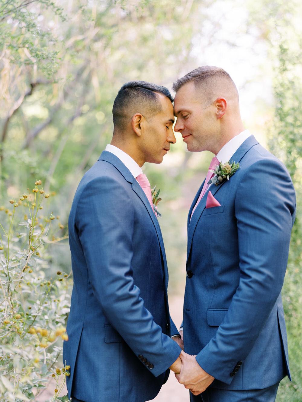 grooms touch foreheads for wedding photo