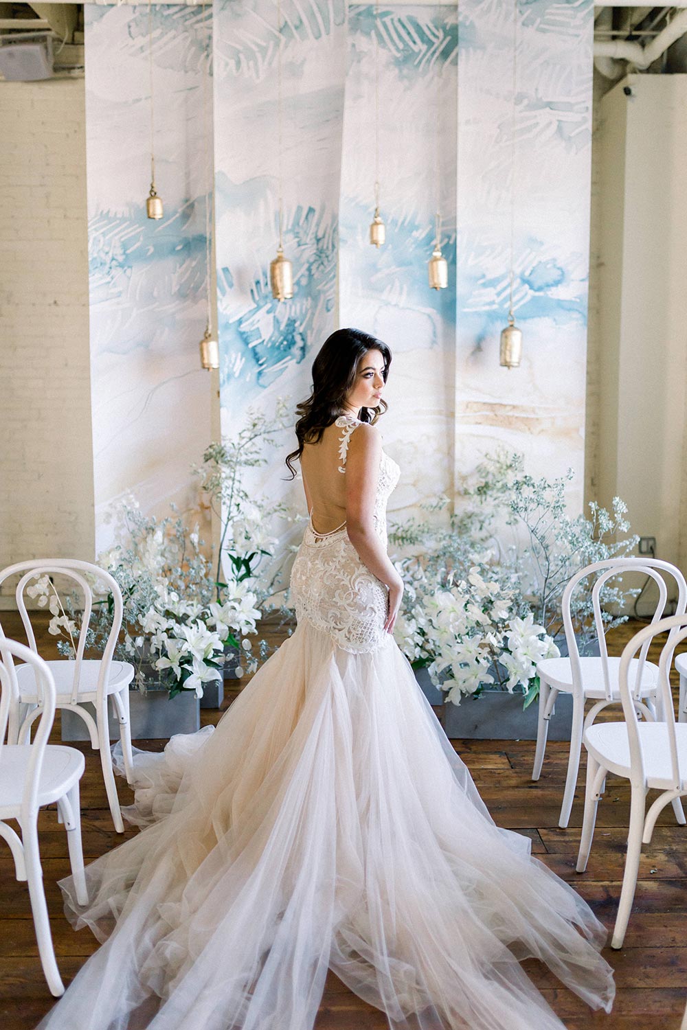 watercolor mural ceremony backdrop with wind chimes and bride in mermaid wedding dress