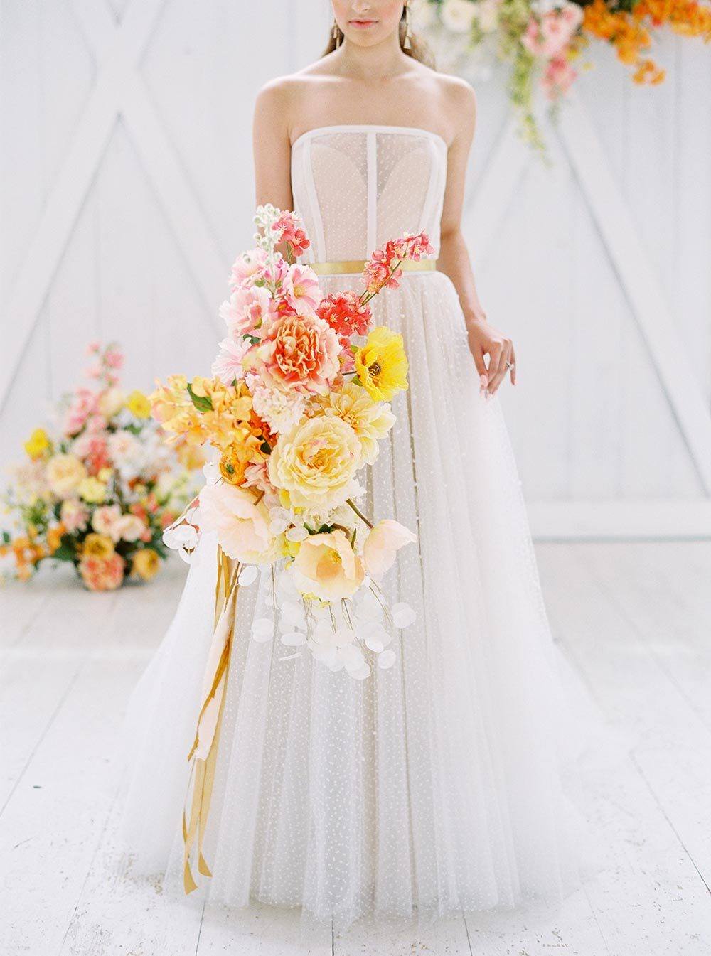 citrus bridal bouquet with modern strapless wedding dress with sequins and corset bodice